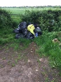 pile of black plastic bin bags containing rubbish