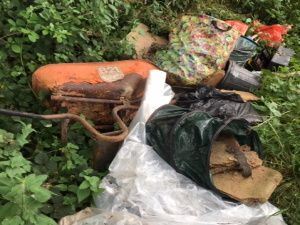 fly tipping at Aston Bridge - wheel barrow and old carpet