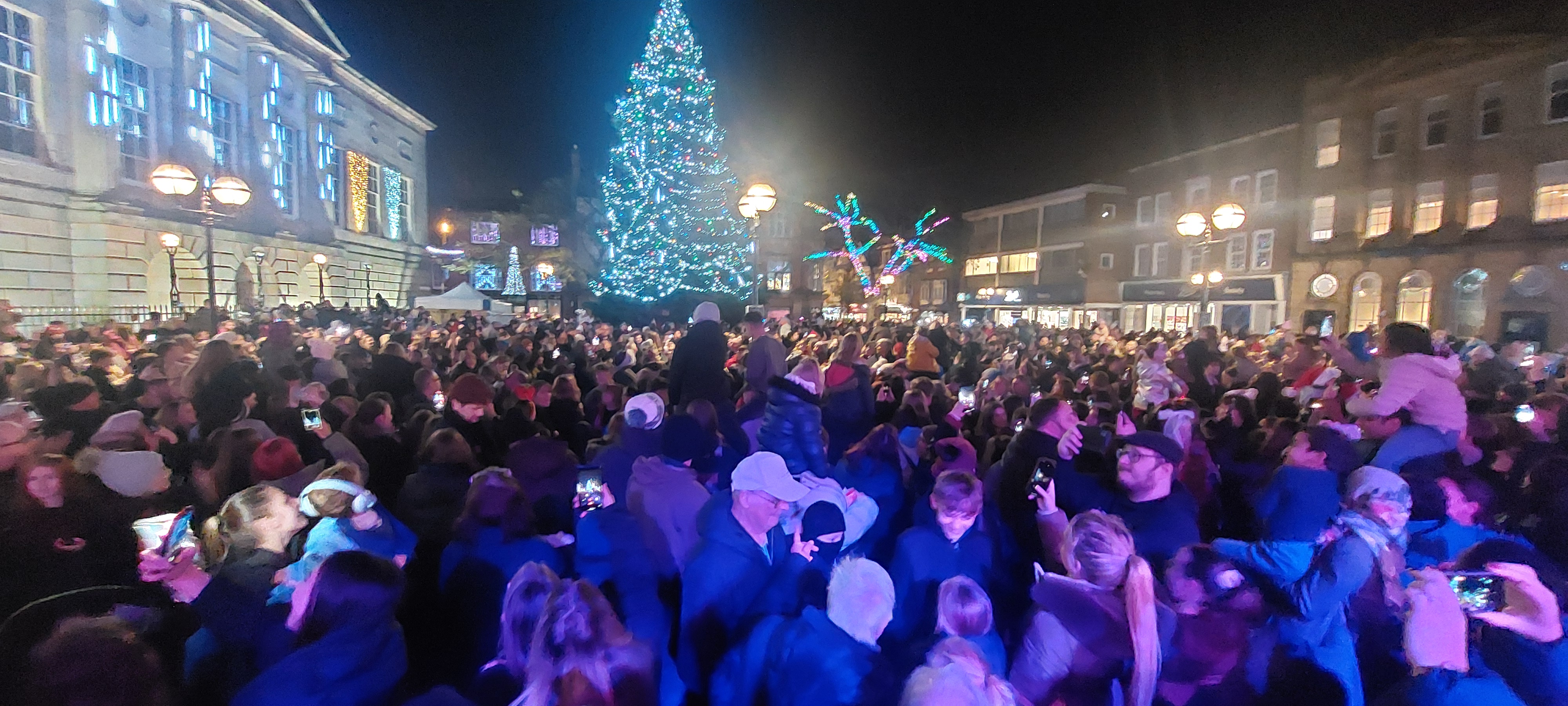 crowds watching christmas lights being switched on in stafford