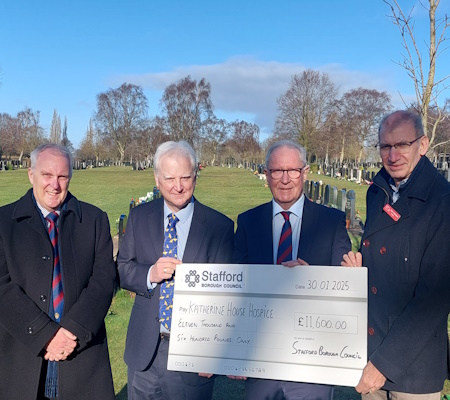 four men accepting large cheque