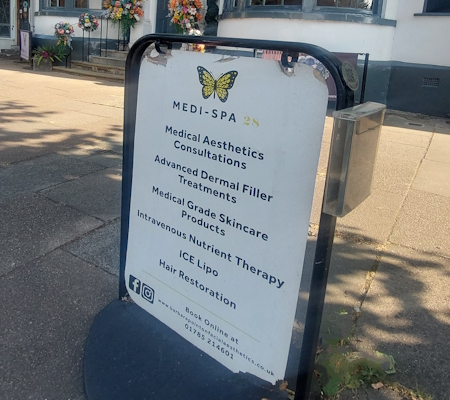 Medi-Spa 28 Board outside the building showing treatments including consultations and hair restoration